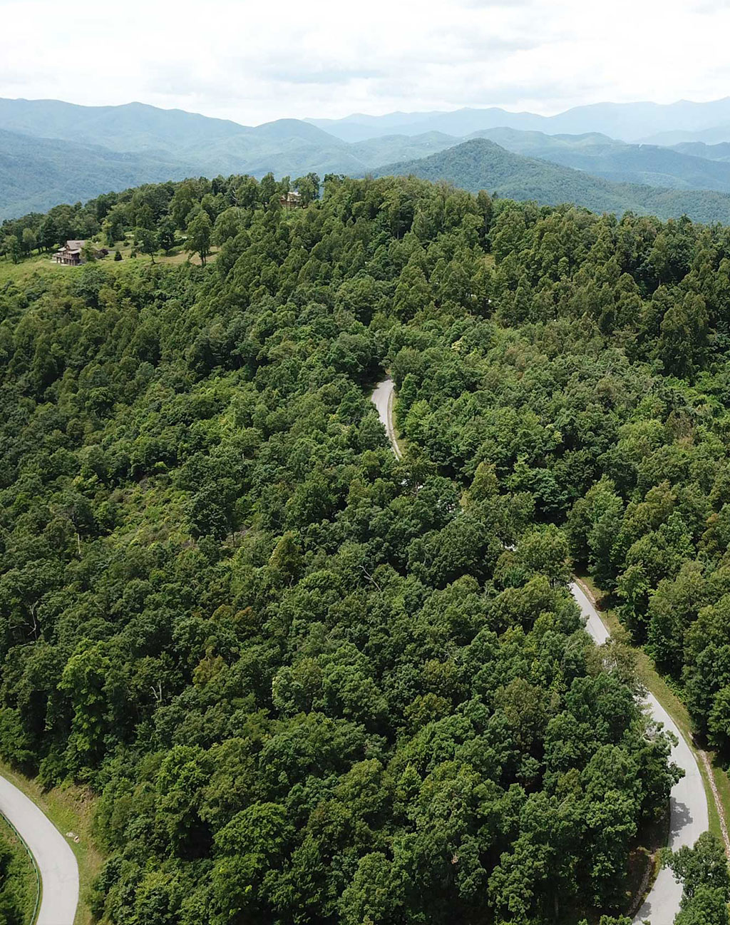 A winding community road under blue mountain skies